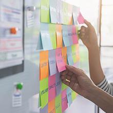Colorful sticky notes with things to do on office board.
