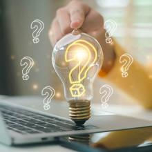 Hand touching the light bulb with the question mark inside. Concept of problem analysis, creativity analytical thinking process.