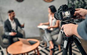 Female journalist interviewing business man 